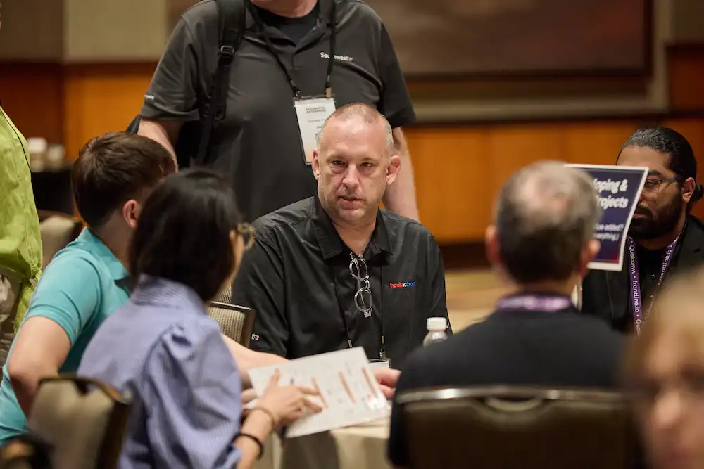 Attendees exchange ideas during a small-group workshop at the 2025 summit