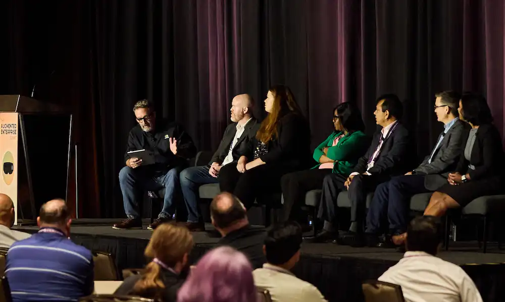 A panel of invited speakers addresses the 2025 summit audience