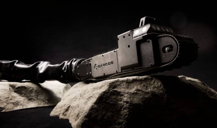 A black and white image of a Seacos chainsaw cutting through a rock or boulder.