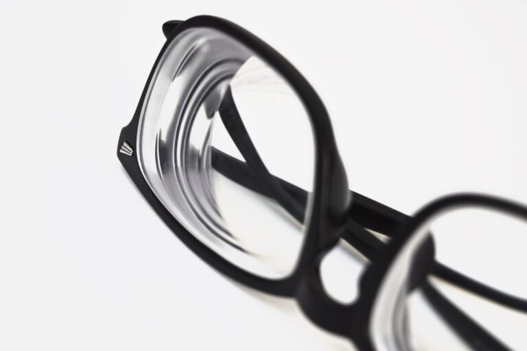 Close-up of black-rimmed eyeglasses with clear lenses on a white background