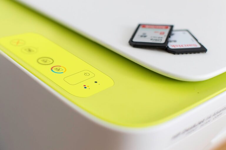 Bright yellow device with buttons and memory cards on a white surface