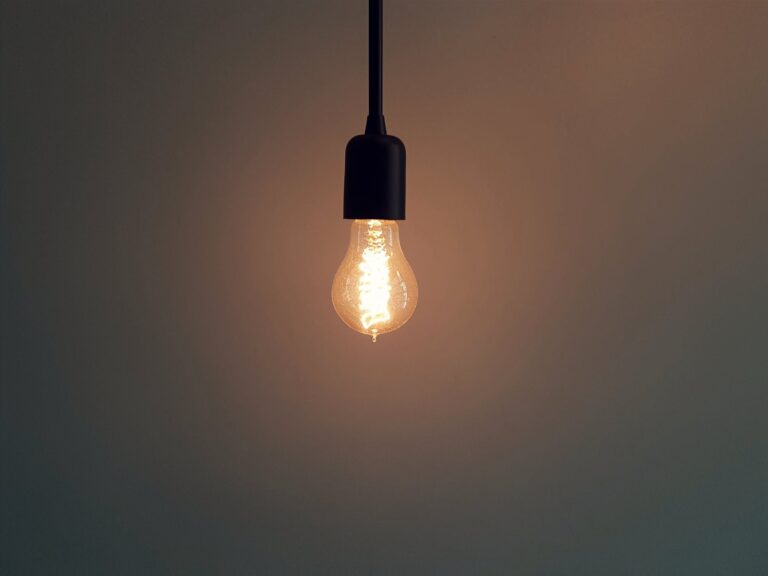 Glowing light bulb in a dark room