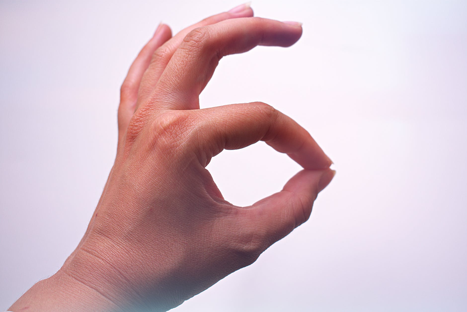 A hand making an okay gesture, representing positive approval or agreement