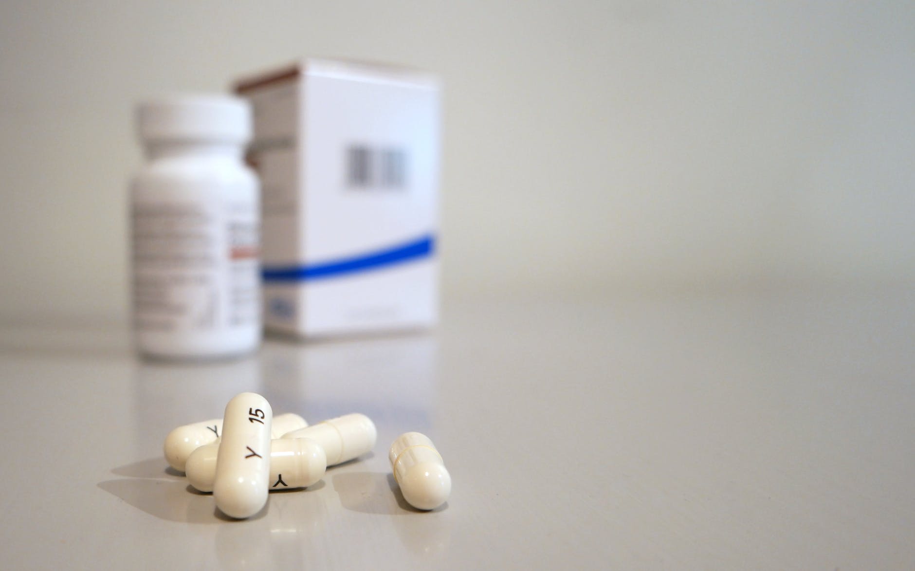 Prescription medication bottles and pills on a surface with blurred background