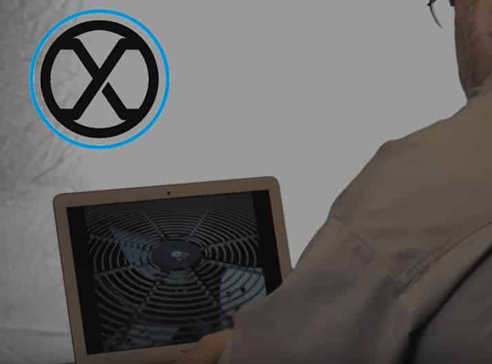 Image of a laptop computer with an abstract spiral pattern on the screen, surrounded by a no-smoking symbol