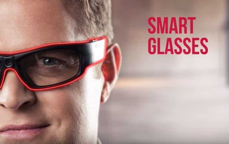 A person wearing red smart glasses, with the text 'SMART GLASSES' visible in the background