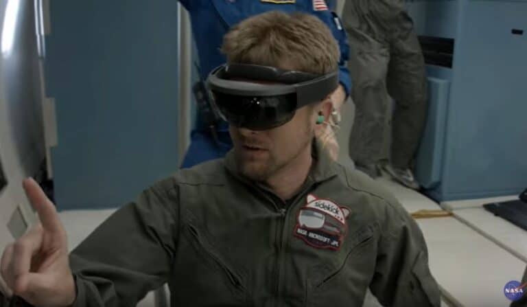 A man wearing a virtual reality headset and military uniform, appearing to interact with a computer interface