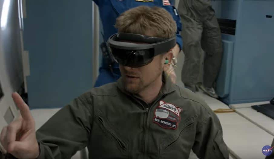 A man wearing a virtual reality headset and military uniform, appearing to interact with a computer interface