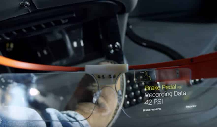 Close-up of a car's brake pedal with a digital display showing recording data and pressure readings