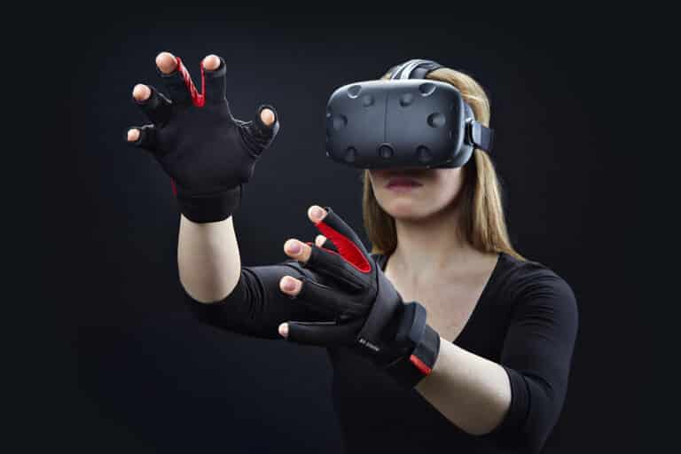 Woman wearing virtual reality headset and gloves, interacting with a virtual world
