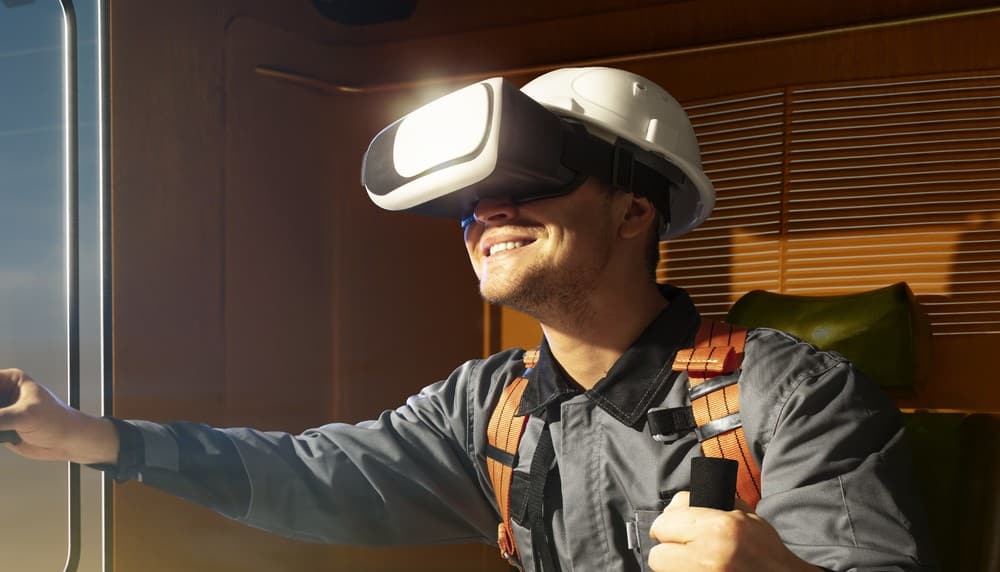 A person wearing a virtual reality headset and safety gear, exploring a digital environment in a construction or industrial setting.