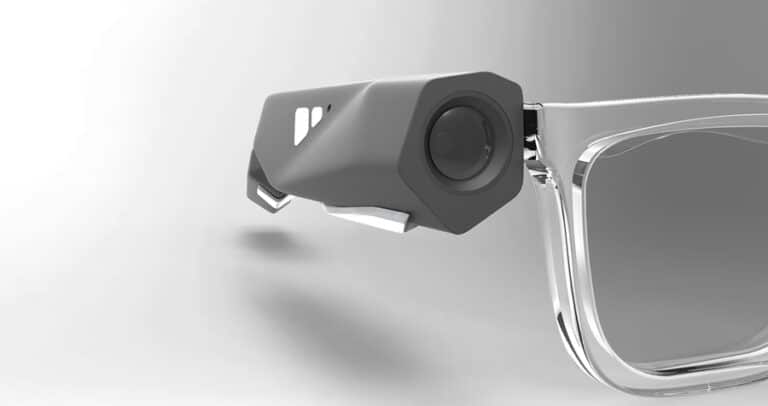 Close-up image of a modern-looking pair of glasses with a camera lens attached to the frame.