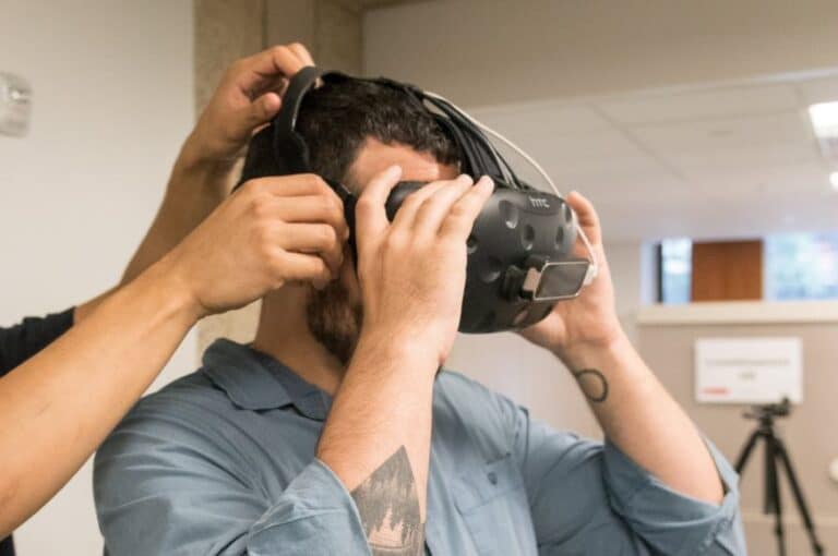 A person wearing a virtual reality headset, immersed in a digital experience