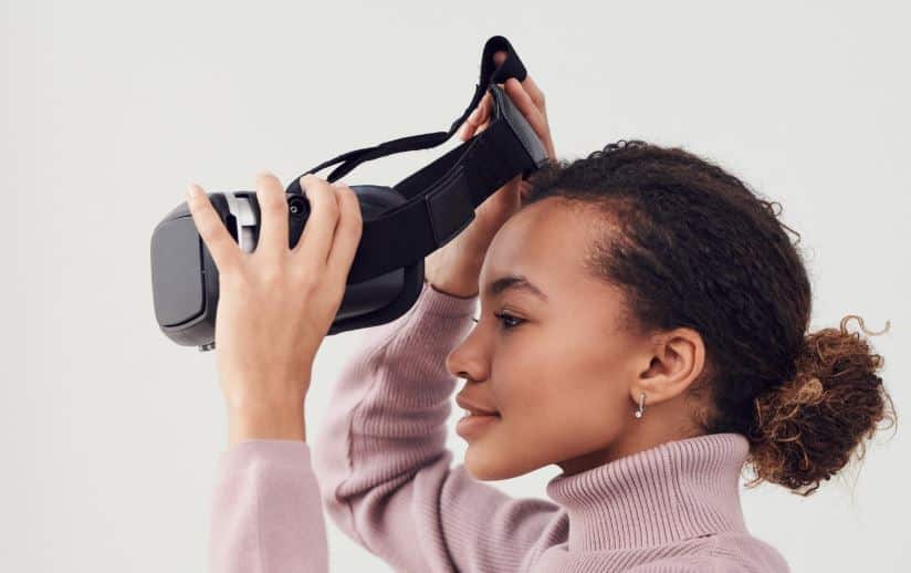 A woman wearing virtual reality headset, exploring immersive digital experiences
