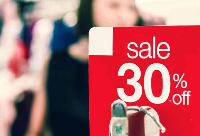 A red sale sign showing a 30% discount offer in a retail store