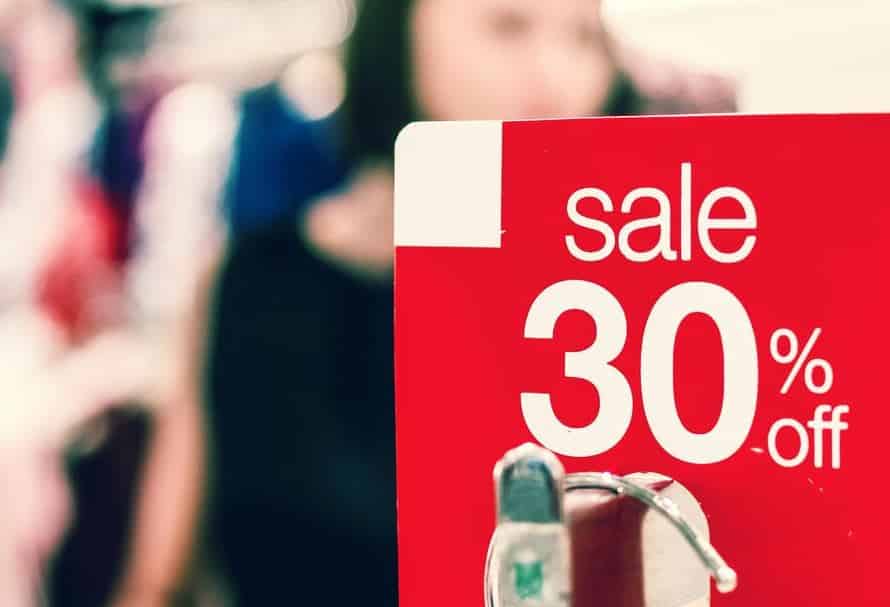 A red sale sign showing a 30% discount offer in a retail store