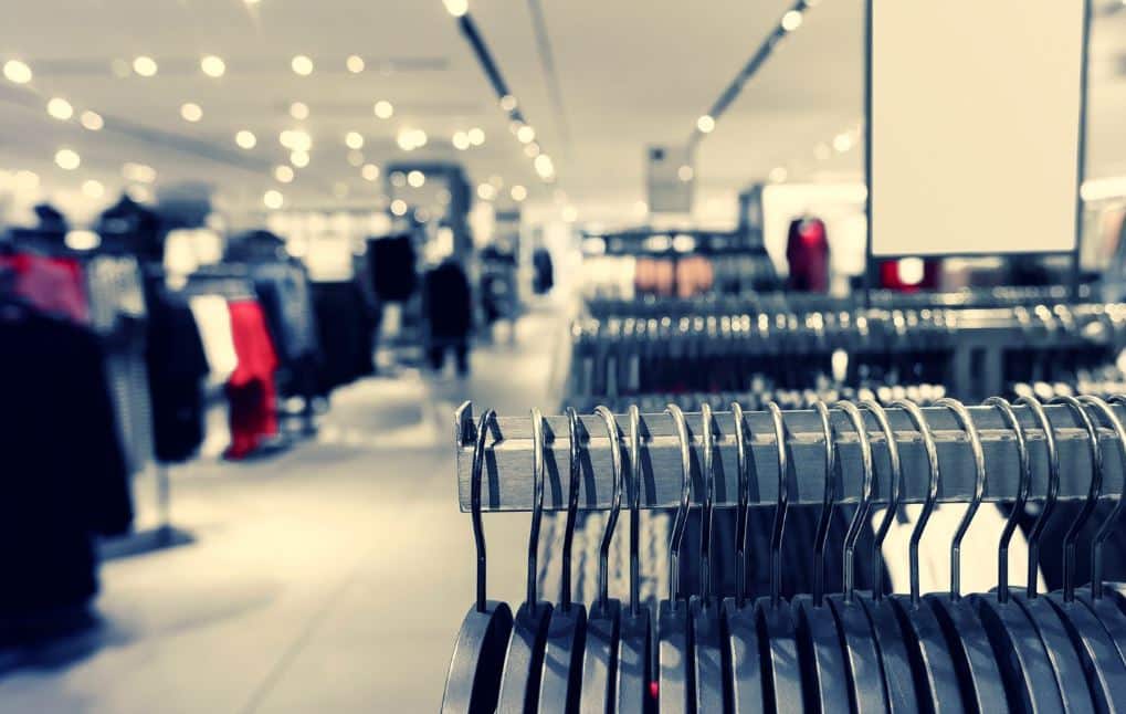 Clothing racks in a retail store with blurred background