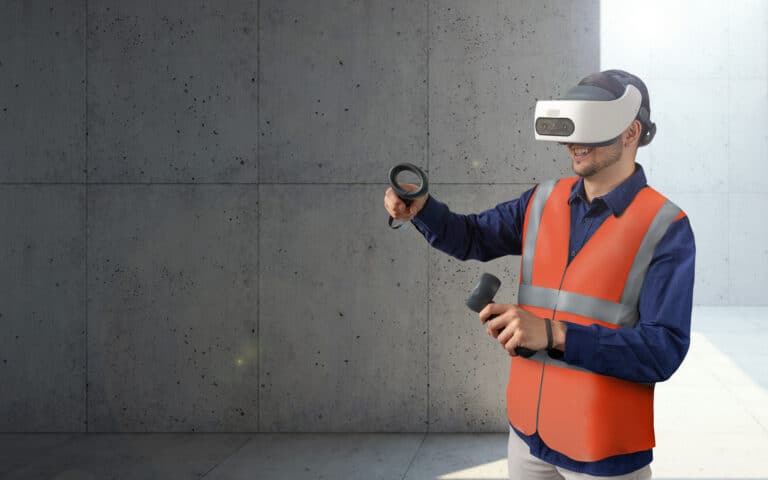 Construction worker using virtual reality headset and controller in front of concrete wall