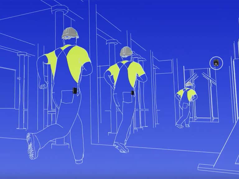 Construction workers in reflective vests and hard hats walking on a construction site
