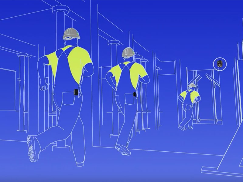 Construction workers in reflective vests and hard hats walking on a construction site