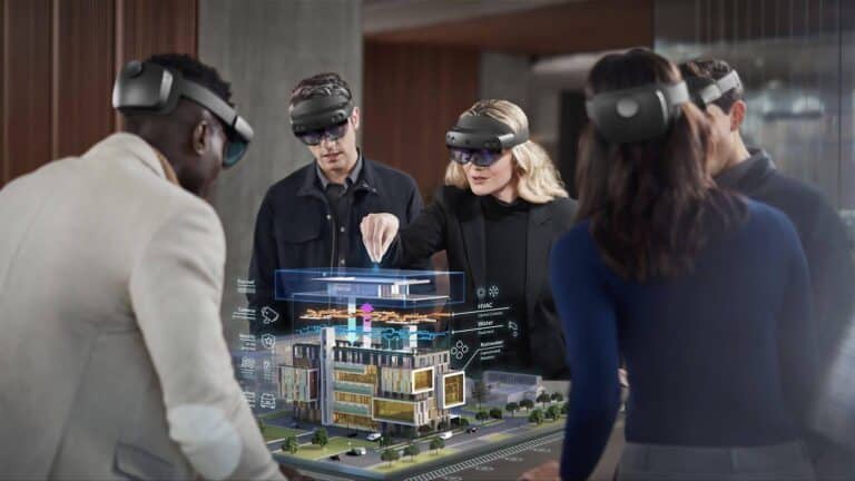 A group of people wearing virtual reality headsets are examining a 3D model of a building, illustrating the use of advanced technology in architecture and design.