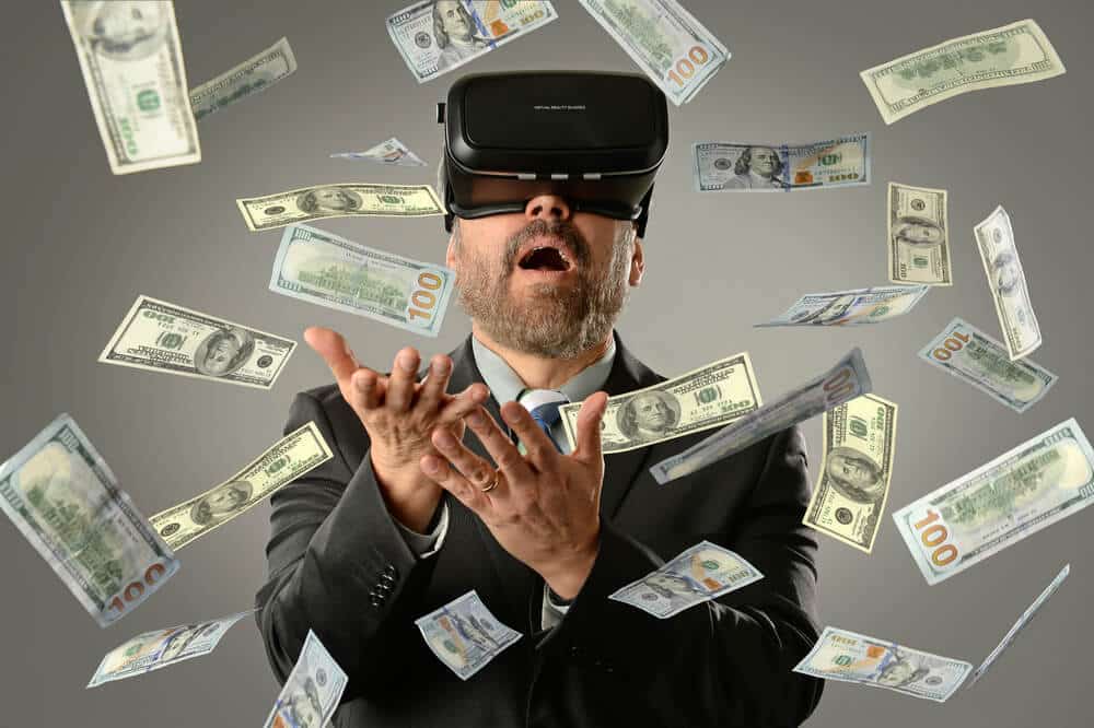 A man wearing a virtual reality headset surrounded by U.S. dollar bills, conveying the concept of making money or wealth in the digital economy