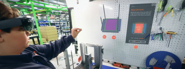 A young person interacting with a display and controls in a workshop or retail environment, surrounded by shelves and tools.