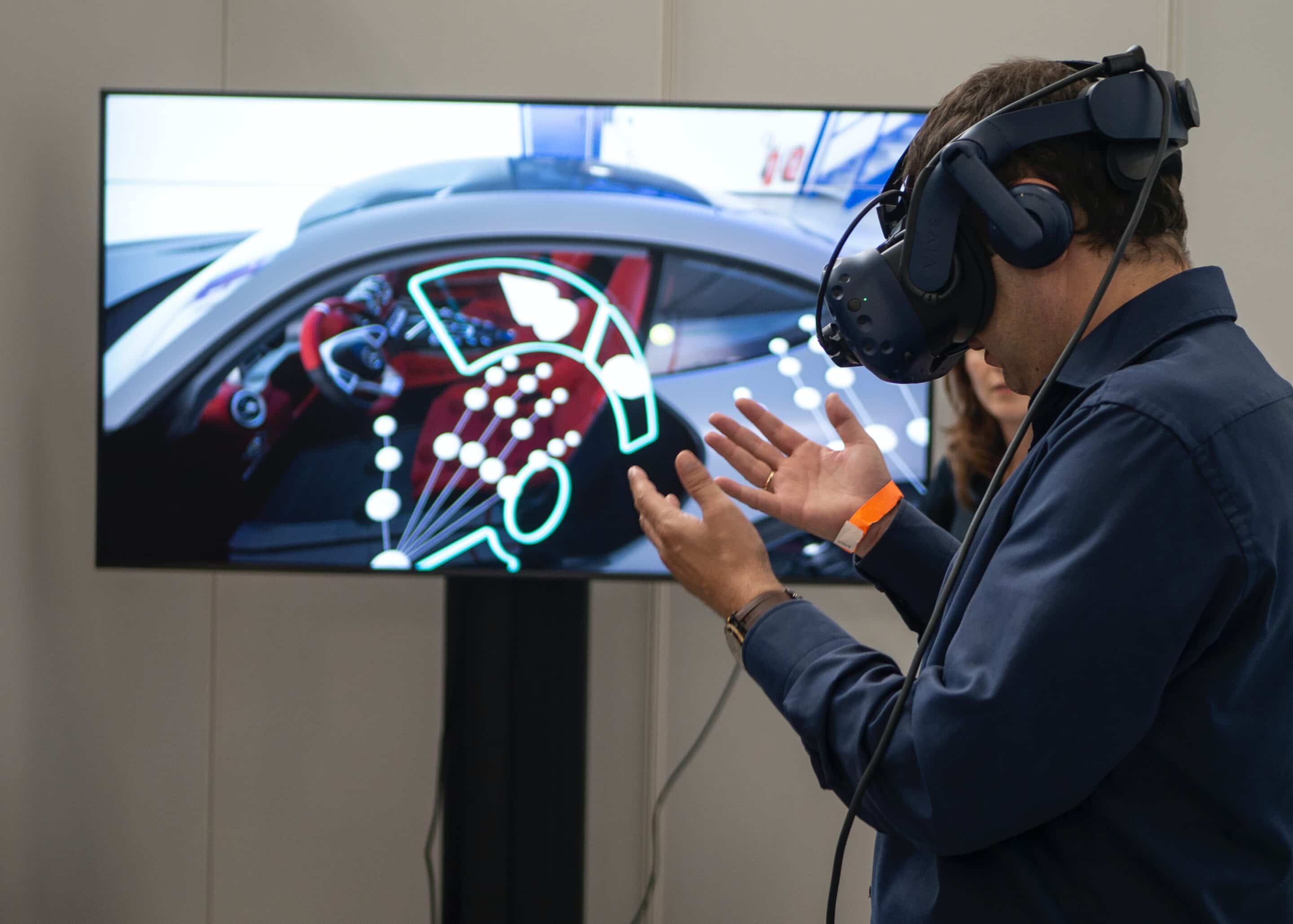 Person using virtual reality headset to control a car dashboard interface