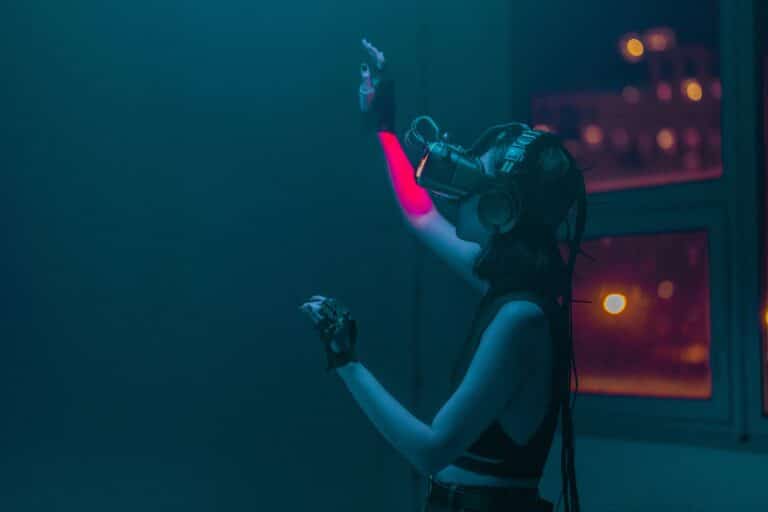 A person wearing a virtual reality headset in a dark, moody setting with colorful lighting