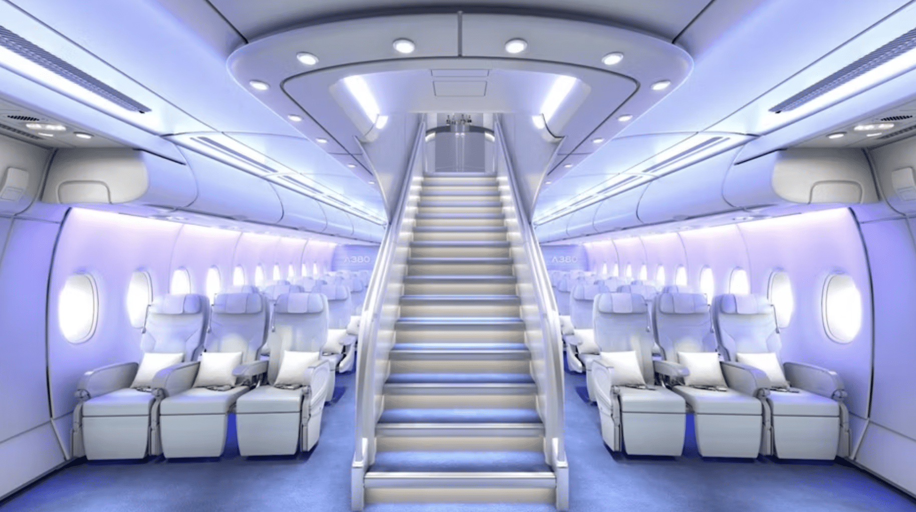 Interior of a modern aircraft cabin with comfortable passenger seats, overhead compartments, and a central stairway leading upwards to the upper deck
